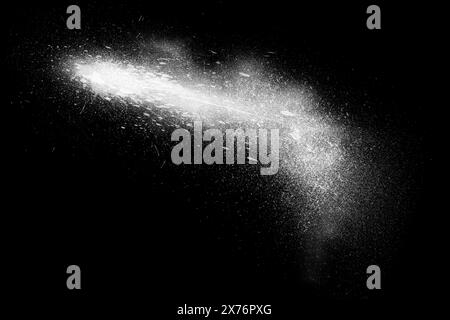 Freeze motion of white powder exploding, isolated on black, dark background. Abstract design of white dust cloud. Particles explosion screen saver, wa Stock Photo