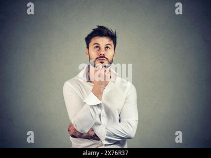 Portrait of a thinking serious man looking up Stock Photo