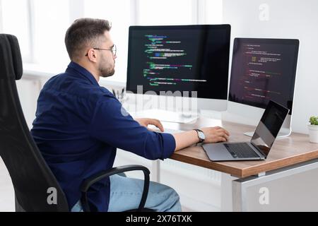 Young programmer working at desk in office Stock Photo