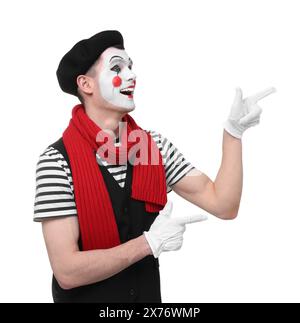 Funny mime artist pointing at something on white background Stock Photo