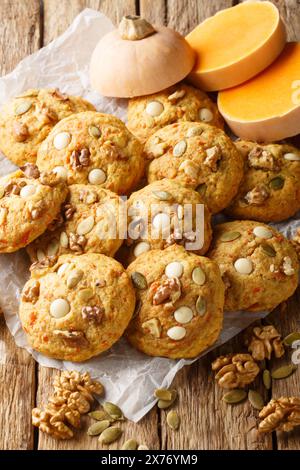 Pumpkin Walnut Chocolate Chip Cookies closeup on the parchment on the wooden table. Vertical Stock Photo