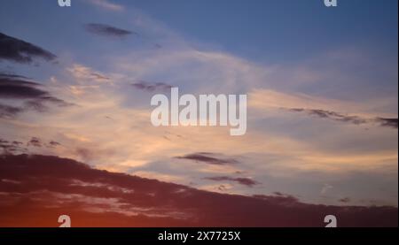 Morning glow illuminates the clouds on a beautiful colorful sky Stock Photo