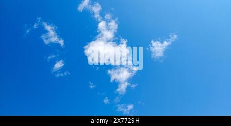 The remains of a small white cloud in the blue sky Stock Photo