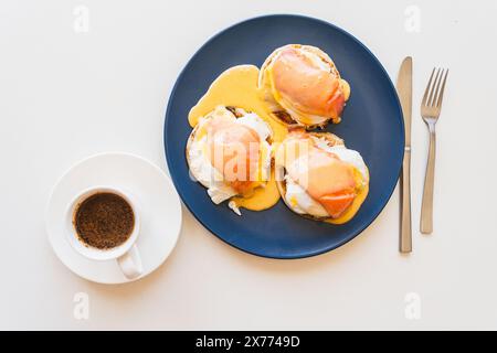 Toast with salmon, poached egg, cream cheese and Goland sauce and cup of coffee. Bruschetta with poached egg and salmon. Open sandwich and cup of coff Stock Photo