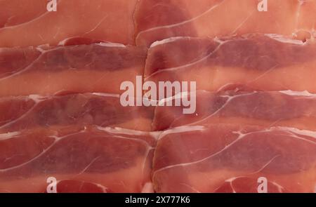 jamon serrano or iberico, spanish ham texture background, traditional prosciutto sliced, dry cured meat ham Stock Photo