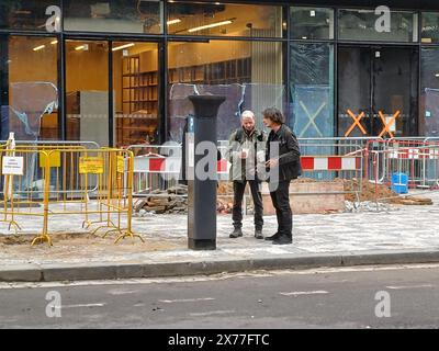 Artist David Cerny (right) at the Maj department store, where the installation of artworks on the facade of building has begun, on 18 May 2024, Prague, Czech Republic. The author of two several-metre-long moving sculptures of butterflies, whose fuselages are imitations of spitfire fighters, is Czech artist David Cerny. They are to become a tribute to Czechoslovak pilots who fought in the Second World War. The civic association Klub za starou Prahu (Club for Old Prague) disagrees with the placement, saying it is typical kitsch. (CTK Photo/Ales Berny) Stock Photo