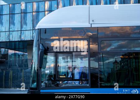 Madrid, Spain. 7 May 2024 Modern electrical low-floor blue bus on a city rout. EMT bus driver on Spanish capital. Municipal vehicle. Urban lifestyle. Stock Photo