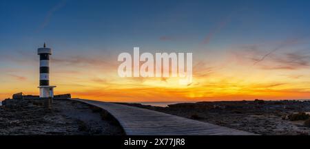 A panorama view of the lighthouse at Colonia Sant Jordi in Mallorca at sunset Stock Photo