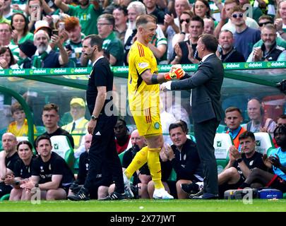 Celtic goalkeeper Joe Hart shakes hands with manager Brendan Rodgers after being substituted for team-mate Scott Bain during the cinch Premiership match at Celtic Park, Glasgow. Picture date: Saturday May 18, 2024. Stock Photo