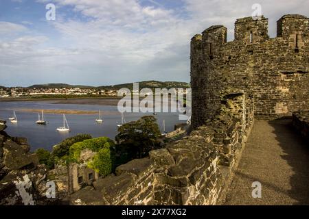 View over the Conwy Estuary with the ruins of the castle walls in the foreground, Conwy, North Wales Stock Photo