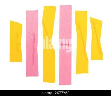 Top view set of wrinkled yellow and pink adhesive vinyl tape or cloth tape in stripes shape is isolated on white background with clipping path. Stock Photo
