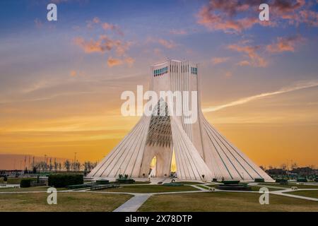 At sunset, locals enjoy a leisurely evening at this iconic landmark in Tehran, the capital of Iran. Azadi Towers, Iran. Stock Photo