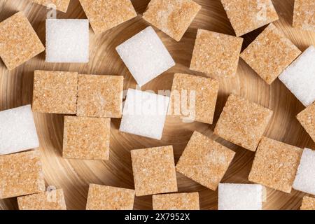Background, cubes cane and white refined sugar in closeup Stock Photo