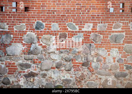 Vintage red brick wall with large white inserts and windows. The texture of the brick. Background. Horizontal. Stock Photo