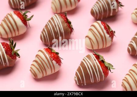 Delicious chocolate covered strawberries on pink background Stock Photo