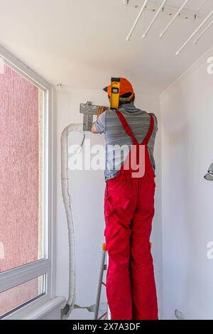 Installing an air conditioner in an apartment office Lviv Ukraine 08.04.2024 Stock Photo