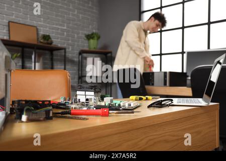 Disassembled computer parts on table in service center, closeup Stock Photo