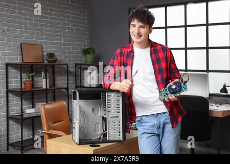 Male technician repairing PC unit in service center Stock Photo