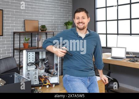 Male technician repairing PC unit in service center Stock Photo