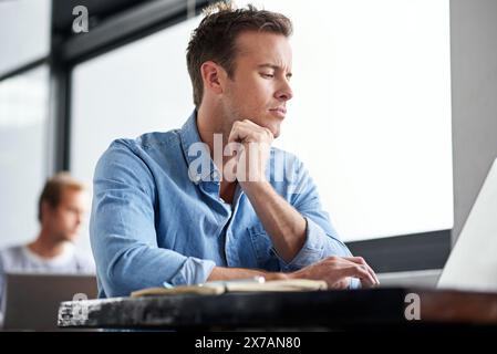 Business man, laptop and online research as web designer for developing, brainstorming or solution. Male person, thinking and tech startup with Stock Photo