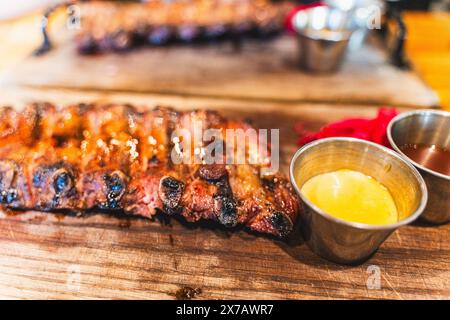 Delicious barbecued ribs seasoned with a spicy basting sauce. Smoked American style pork ribs. Top view. Selected focus. High quality photo Stock Photo
