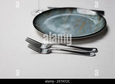 Table service set on the table. plates and fork. elegantly set table. Stock Photo