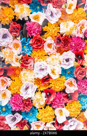 The wall is made of bright multi-colored flowers. Floral texture for the background of the design. Vertical Photo. High quality photo Stock Photo