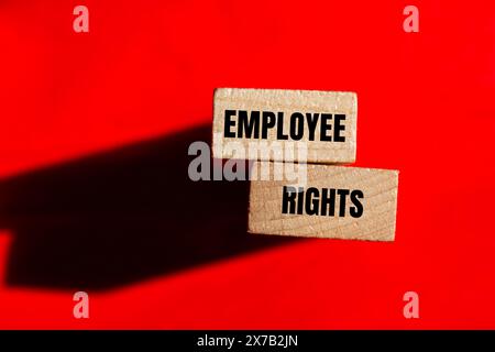 Employee rights words written on wooden blocks with red background. Conceptual employee rights symbol. Copy space. Stock Photo