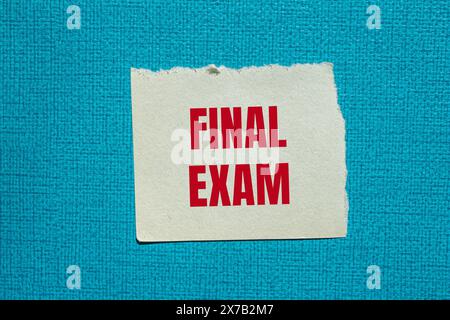 Final exam words written on ripped white paper with brown background ...
