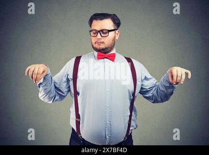 a man weighs all the pros and cons when making a decision Stock Photo