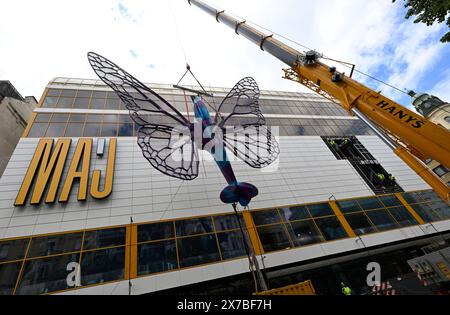 Prague, Czech Republic. 19th May, 2024. Installation of artworks on the facade of renovated Maj department store on 19 May 2024, Prague, Czech Republic. The author of two several-metre-long moving sculptures of butterflies, whose fuselages are imitations of spitfire fighters, is Czech artist David Cerny. They are to become a tribute to Czechoslovak pilots who fought in the Second World War. The civic association Klub za starou Prahu (Club for Old Prague) disagrees with the placement, saying it is typical kitsch. Credit: Katerina Sulova/CTK Photo/Alamy Live News Stock Photo