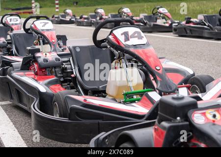 Red black go-karts on the side of a track Stock Photo - Alamy