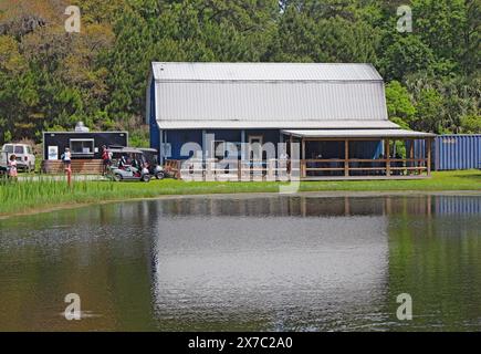 DAUFUSKIE ISLAND, SOUTH CAROLINA - April 6 2023: Front view of the Daufuskie Island Rum Company and reflection in a pond. Stock Photo