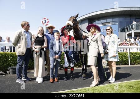 Mutasarref and jockey Colin Keane (centre) with owner Eleanora Kennedyon (second right) and trainer Ger Lyons (third left) after winning the Owenstown Stud Stakes at Naas Racecourse in County Kildare. Picture date: Sunday May 19, 2024. Stock Photo