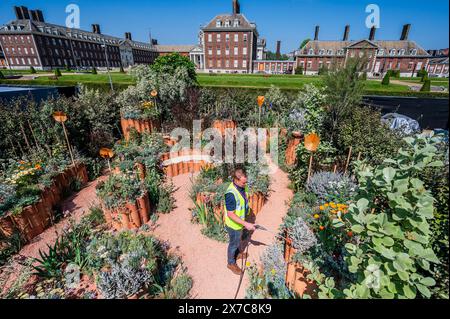 London, UK. 19th May, 2024. The World Child Cancer's Nurturing Garden, Designed by Giulio Giorgi, Built by Landesigns Ltd. - The RHS Chelsea Flower Show 2024. It runs from 20-25 May. Credit: Guy Bell/Alamy Live News Stock Photo