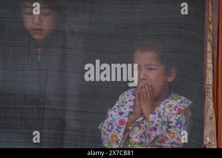 A Kashmiri girl weeps as people carry the dead body of slain former sarpanch or village head Aijaz Sheikh during his funeral procession after suspected militants fired upon him at his home last night in Heerpora Shopian, south of Srinagar. A former sarpanch or village head was slain and an Indian tourist couple injured in two separate militant strikes in Shopian and Anantnag last night, ahead of the Baramulla parliamentary constituency elections in Jammu and Kashmir. Stock Photo