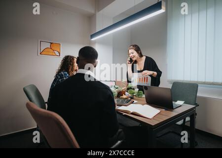 Multicultural team analyzing growth statistics together in a modern office Stock Photo