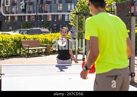 Family playing table tennis outside house Stock Photo