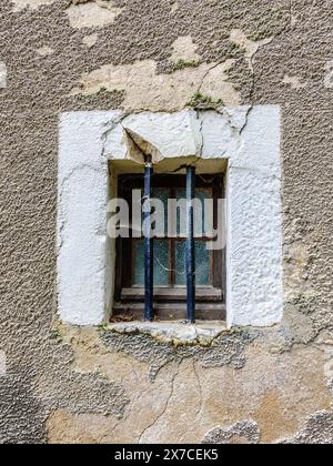 Small old domestic window fitted with iron security bars - Argenton-sur-Creuse, Indre (36), France. Stock Photo