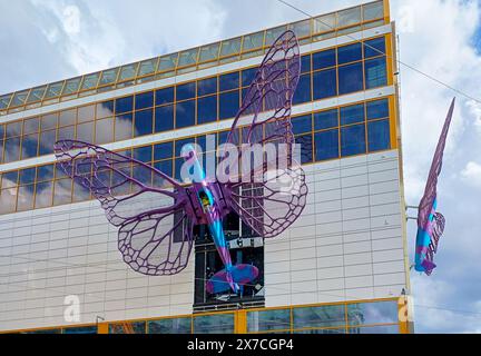 Prague, Czech Republic. 19th May, 2024. Installation of artworks on the facade of renovated Maj department store on 19 May 2024, Prague, Czech Republic. The author of two several-metre-long moving sculptures of butterflies, whose fuselages are imitations of spitfire fighters, is Czech artist David Cerny. They are to become a tribute to Czechoslovak pilots who fought in the Second World War. The civic association Klub za starou Prahu (Club for Old Prague) disagrees with the placement, saying it is typical kitsch. Credit: Berny Ales/CTK Photo/Alamy Live News Stock Photo