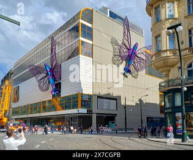 Prague, Czech Republic. 19th May, 2024. Installation of artworks on the facade of renovated Maj department store on 19 May 2024, Prague, Czech Republic. The author of two several-metre-long moving sculptures of butterflies, whose fuselages are imitations of spitfire fighters, is Czech artist David Cerny. They are to become a tribute to Czechoslovak pilots who fought in the Second World War. The civic association Klub za starou Prahu (Club for Old Prague) disagrees with the placement, saying it is typical kitsch. Credit: Berny Ales/CTK Photo/Alamy Live News Stock Photo