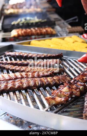 Electric grill in the food court at the fair. Large round rotating grill with assorted meats and vegetables. Rotary grill. Street food. Open air fair Stock Photo