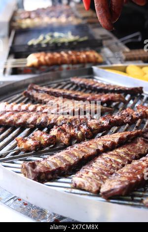 Electric grill in the food court at the fair. Large round rotating grill with assorted meats and vegetables. Rotary grill. Street food. Open air fair Stock Photo