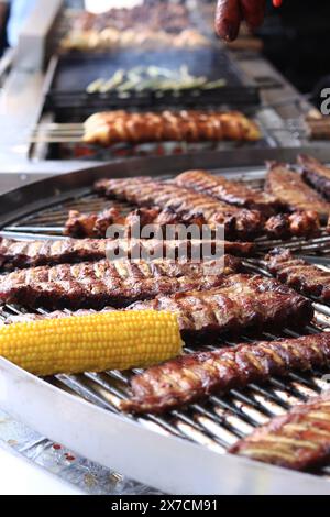 Electric grill in the food court at the fair. Large round rotating grill with assorted meats and vegetables. Rotary grill. Street food. Open air fair Stock Photo