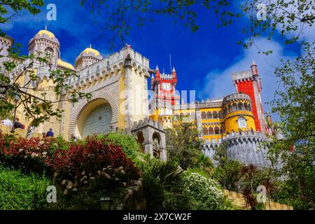 The Pena Palace or Palácio da Pena historic palace castle viewed from the Coach Yard in Sintra, Portugal. The fairytale castle palace is considered one of the finest examples of 19th century Portuguese Romanticism architecture in the world. Stock Photo