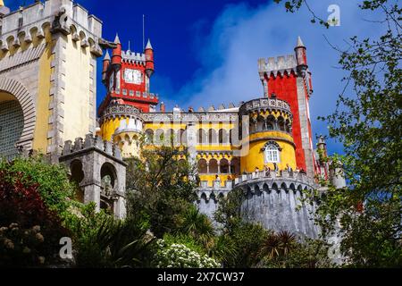 The Pena Palace or Palácio da Pena historic palace castle viewed from the Coach Yard in Sintra, Portugal. The fairytale castle palace is considered one of the finest examples of 19th century Portuguese Romanticism architecture in the world. Stock Photo