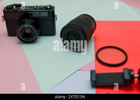 This image is about camera and flash on a colored background the concept of the photographer Stock Photo