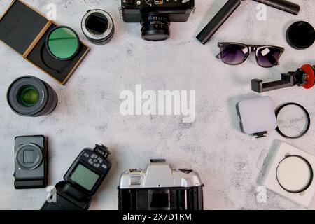 A meticulously organized arrangement of camera equipment, showcasing a DSLR camera, various lenses, filters, and essential accessories Stock Photo