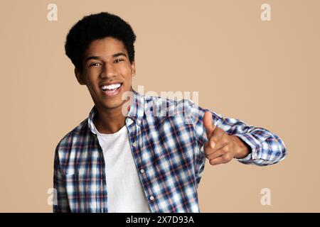 Hey you. Cheerful black guy indicating happily at camera Stock Photo