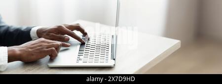 Cropped of african american man in suit typing on laptop Stock Photo